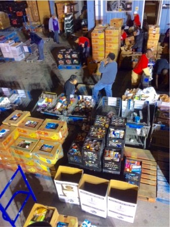Volunteers sorting food back at the Manna House.